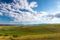 Beautiful blue sky with white clouds over green agricultural fields at summertime Royalty Free Stock Photo