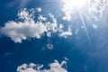 Beautiful Blue Sky with White Cumulus Clouds and Sunbeams Royalty Free Stock Photo