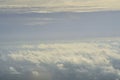 Beautiful blue sky with white puffy clouds in two levels with clear sky in between. Amazing view from airplane window taken up in Royalty Free Stock Photo