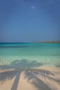 Beautiful blue water beach in a tropical paradise, with bungalows in the background in Maldives