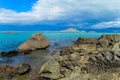 Beautiful blue water and rocks lake coast