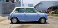 Beautiful Blue with White classic Mini cooper parked on street or road with building background. Old vehicle, Transportation Royalty Free Stock Photo