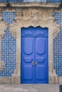 Beautiful blue wooden door with traditional portuguese tiles Royalty Free Stock Photo