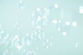 Beautiful blurry bokeh clear soap bubbles float on green background