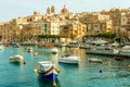 Beautiful boats in Valletta harbour with cityscape on the background Royalty Free Stock Photo