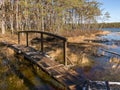 Beautiful bog landscape, curved wooden bridge over ditch