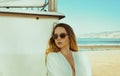 Beautiful bohemian styled and tanned girl , tropical beach in sunlight. Beautiful young woman standing at sea beach in sensual Royalty Free Stock Photo