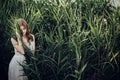 Beautiful boho girl embracing in grass at sunset light near lake Royalty Free Stock Photo