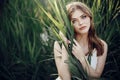 Beautiful boho girl embracing in grass at sunset light near lake Royalty Free Stock Photo