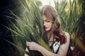 Beautiful boho girl posing in grass at sunset light near lake. a Royalty Free Stock Photo