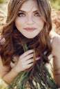 Beautiful boho girl posing in grass at sunset light near lake. a Royalty Free Stock Photo