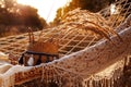 Boho style, hammock in spikelet background at sunset. Lightness and simplicity.