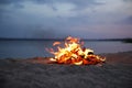 Beautiful bonfire with burning firewood on beach