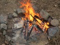 A beautiful bonfire made of coals, twigs, logs and leaves.