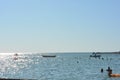 Beautiful border between the blue sky and the black sea with small waves and fine golden and bright reflections of the sun on the Royalty Free Stock Photo