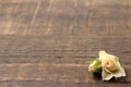 A beautiful bottle of beige mini roses on a brown wooden table. space for text