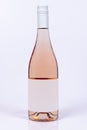 Beautiful burgundy style bottle of rose wine on white surface and background