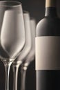 beautiful bottle of red wine three glasses close-up fragment vertical photo. a white empty copy space label Royalty Free Stock Photo