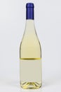 Beautiful burgundy bottle of white wine on white surface and background