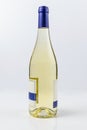 Beautiful burgundy bottle of white wine on white surface and background