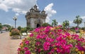 Beautiful Bougainvillea Plant With The Victory Gate Patuxai In The Background In The Center Of Vientiane, Laos