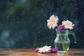 Beautiful bouquet with Gerbera daisy flowers and Chrysanthemum in vase on wooden table outdoors under the rain with droplets Royalty Free Stock Photo