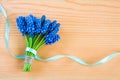Beautiful bouquet of blue spring muscari flowers on a wooden background