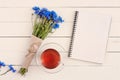 Beautiful bouquet of blue wildflowers with an empty memo pad for
