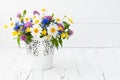 Beautiful bouquet of bright wildflowers in basket over old rustic table. Mothers day greeting card concept. Royalty Free Stock Photo