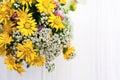 Beautiful bouquet of bright wildflowers in watering can on white wooden table, top view Royalty Free Stock Photo