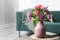 Beautiful bouquet of colorful tulip flowers on coffee table in room, space for text Royalty Free Stock Photo
