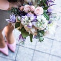 Beautiful bouquet with delicate flowers. Pink-white-purple bouquet. Bridal bouquet in female hands