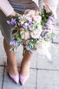 Beautiful bouquet with delicate flowers. Pink-white-purple bouquet. Bridal bouquet in female hands