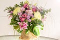 Beautiful bouquet of different flowers in a vase on the table. Festive bouquet for birthday. The art of the florist Royalty Free Stock Photo