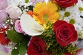 Beautiful bouquet of flowers in bright colors. It consists of roses, gerberas and decorative grass.