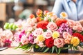 Florist making holiday bouquet of flowers at workplace