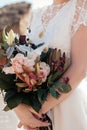Beautiful bouquet of flowers in the hands of the bride vertical Royalty Free Stock Photo