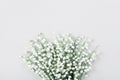 Beautiful bouquet of flowers lily of the valley on pastel table from above. Minimal composition and flat lay style.