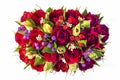 A beautiful bouquet of flowers made of red and yellow roses, green leaves and red and purple berries. Top view. Isolated image. Royalty Free Stock Photo