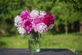 Beautiful bouquet of flowers with red, pink and white peony in garden Royalty Free Stock Photo