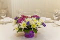 Beautiful bouquet of flowers on the table. Festive decoration of the banquet. Space for text