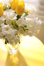 Bouquet with fresh freesia flowers in vase on table near window Royalty Free Stock Photo