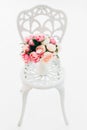 Beautiful bouquet peonies on forged vintage chair in white room