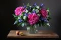 Beautiful bouquet of peonies, irises and Jasmine in the jar on t