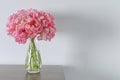 Beautiful bouquet of pink peonies in vase on wooden table against white background. Space for text Royalty Free Stock Photo