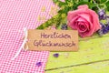 Rose flowers bouquet with greeting card and german text, Herzlichen Glueckwunsch, means congratulation