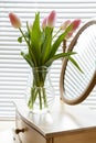 Beautiful bouquet of pink tulips and mirror