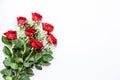 Beautiful bouquet of red roses and baby`s breath white flowers isolated on a white background, top view with copy space Royalty Free Stock Photo