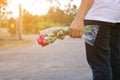 A beautiful bouquet of red roses is held on hand of middle aged woman on nature outdoor with sunshine effect background. Love and Royalty Free Stock Photo