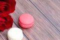 Beautiful bouquet of red roses and some macaroons